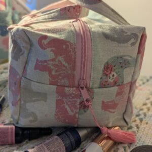 Large canvas elephant cosmetic bag with two inside pockets and soft pink lining fabric comes with zip tassel