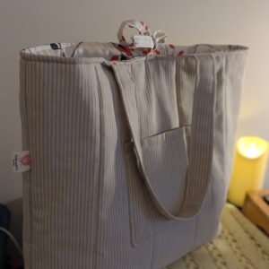 Large Herringbone Tote bag with floral lining. Inside and outside pocket with shoulder straps and floral tier to close. Perfect for a work/school bag or simply use as an everyday shopper bag